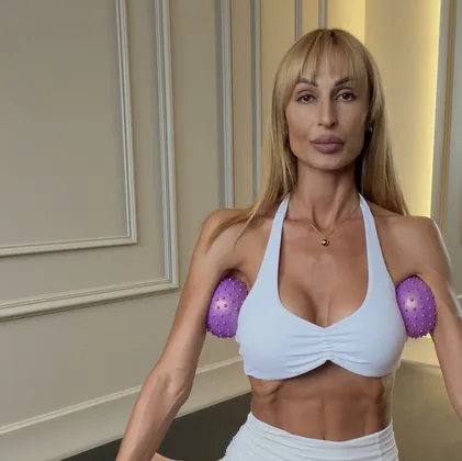 Front view of the massage-ball routine, a ball pressed under each arm