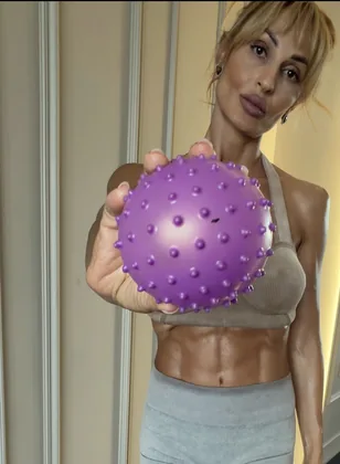 Close-up of a spiked massage ball held toward the camera